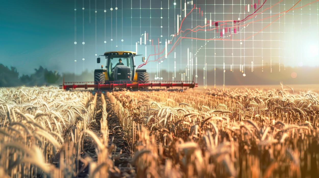 A tractor is harvesting wheat in a field while stock charts in the background reflect the economic impact on agricultural products.